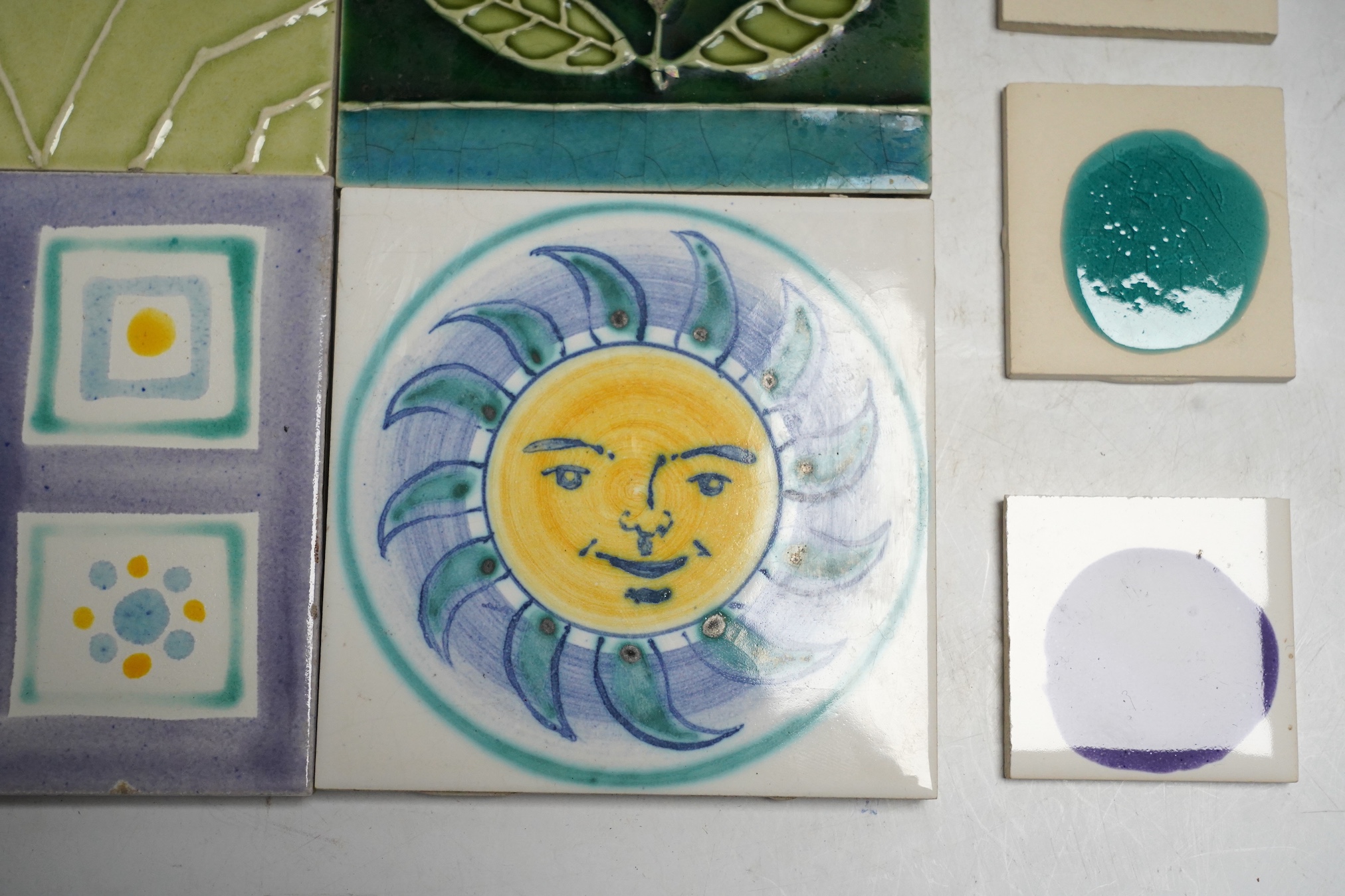 A collection of forty-three Kenneth Clark ceramic tiles and a quantity of related smaller spacer tiles, larger tiles 10x10cm